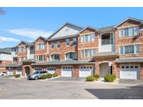 Charming multi-Gathering brick townhome with well-maintained landscaping and attached garages, perfect for comfortable living at 8944 Fox Dr # 6-103, Denver, CO 80260