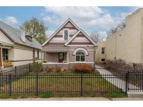Charming home featuring unique architectural details and a well-maintained front yard with black metal fence at 2224 N Humboldt St, Denver, CO 80205