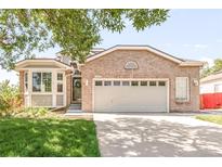 Charming brick home featuring an attached two-car garage, well-maintained lawn, and lovely bay window at 5282 E 116Th Ave, Thornton, CO 80233