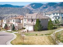 Charming home boasts mountain views, neutral paint, tile roof, and manicured front yard in a desirable neighborhood at 2559 S Kendrick St, Lakewood, CO 80228