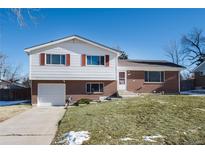 Brick ranch house with attached garage and landscaped lawn at 6740 S Clarkson St, Centennial, CO 80122