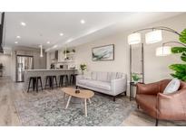 Bright living room featuring modern furnishings, an open floor plan, and a cozy atmosphere at 1318 Yates St, Denver, CO 80204