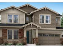 Inviting two-story home featuring stone accents, a covered porch, and a two-car garage at 14571 Hudson St, Thornton, CO 80602