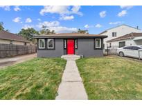 Newly renovated gray house with a red door and well-maintained lawn at 4445 Milwaukee St, Denver, CO 80216