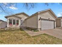 Charming single-Gathering home featuring an attached two-car garage and a well-manicured front lawn at 5688 Alcott St, Denver, CO 80221