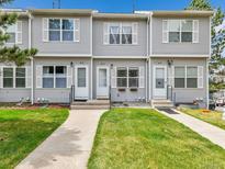 Charming townhome with well-maintained lawn, sidewalk, and symmetrical design at 2074 Oakcrest Cir, Castle Rock, CO 80104