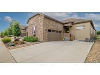 Beautiful stone and siding home with a wide driveway leading to an attached two-car garage at 3418 New Haven Cir, Castle Rock, CO 80109