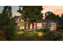 Charming home with bright shutters and an attached garage, surrounded by mature trees at 10463 Kipling Ct, Broomfield, CO 80021