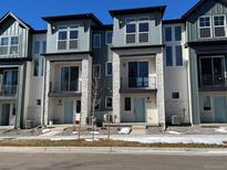 Modern townhome exteriors feature stone accents, balconies, and stylish curb appeal at 11958 W 57Th Pl, Arvada, CO 80002