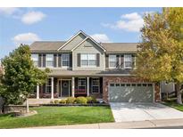 Two-story house with brick and siding, a large front yard, and a two-car garage at 11690 Stoneybrooke St, Parker, CO 80138