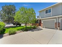 Charming two-story home with a well-maintained front yard and attached garage at 411 S Cody Ct, Lakewood, CO 80226