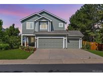 Charming two-story home with a well-maintained lawn, mature trees and a three-car garage at 18899 E Whitaker Cir, Aurora, CO 80015