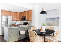 Modern kitchen with stainless steel appliances and light wood cabinets at 16091 E Geddes Dr # 74, Aurora, CO 80016