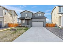 Charming two-story home features a well-maintained lawn and a spacious two-car garage at 6211 Bauer Dr, Frederick, CO 80504