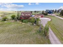 Expansive aerial view of a two-story home, large lot, and a circular driveway at 2146 Savage Rd, Elizabeth, CO 80107