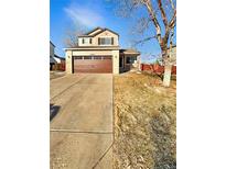 Charming two-story home with a two-car garage and well-maintained front yard at 20885 Omaha Ave, Parker, CO 80138