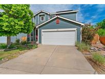 Charming home featuring a well-maintained yard, attached garage and light blue siding at 1086 Mockingbird St, Brighton, CO 80601