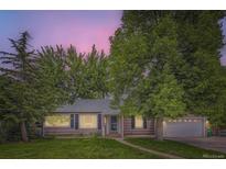 Charming single-story home with mature trees, manicured lawn, and attached garage, with inviting curb appeal at 1697 W Powers Ave, Littleton, CO 80120