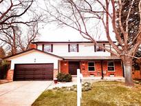 Charming two-story home featuring a brick and siding exterior, attached garage, and well-manicured lawn at 8736 E Easter Ave, Centennial, CO 80112