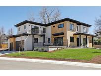 Modern home showcasing a unique two-tone design with a well-manicured lawn and a visible garage at 2900 S Adams St, Denver, CO 80210