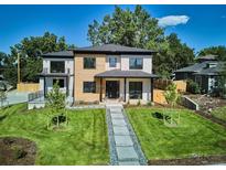 Modern two-story home with wood and stucco exterior, professional landscaping, and inviting walkway at 2900 S Adams St, Denver, CO 80210