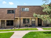 Charming townhome featuring a brick facade, well-maintained lawn, and inviting curb appeal at 12993 W 20Th Ave, Golden, CO 80401