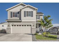 Charming two-story home featuring a two-car garage, stone accents, and well-manicured lawn at 21038 E Quincy Pl, Aurora, CO 80015