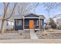 Charming bungalow with a bright orange door and new siding at 3736 S Lincoln St, Englewood, CO 80113