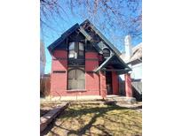 Charming red brick home featuring a covered porch and unique architectural details at 1449 N Downing St, Denver, CO 80218