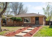 Charming brick home with a well-maintained front yard and inviting entryway at 1148 N Clinton St, Aurora, CO 80010