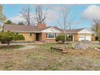 Single Gathering home with brick exterior, an attached two car garage, and mature landscaping at 1345 Laredo St, Aurora, CO 80011