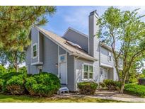 Charming townhome with light gray siding, mature landscaping, and a cozy front entrance at 3912 S Richfield Way, Aurora, CO 80013