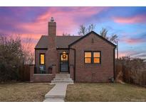 Brick home with a charming front porch and well-manicured lawn at 3633 N Cook St, Denver, CO 80205