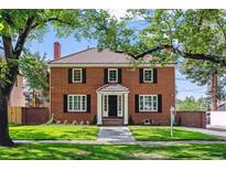 Brick house with a classic design, manicured lawn, and walkway at 5022 E 17Th Ave, Denver, CO 80220