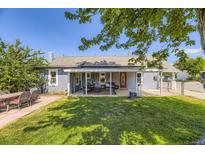 Charming home featuring a covered porch with outdoor seating and a spacious, well-maintained backyard at 235 W Lehigh Ave, Englewood, CO 80110