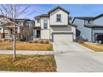 Charming two-story home featuring a well-maintained front yard and a two-car garage at 6491 N Danube St, Denver, CO 80249
