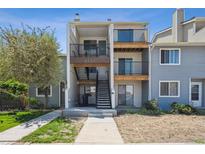 Inviting exterior view of a multi-level home with private balconies and well-maintained landscaping at 6007 Yarrow St # I, Arvada, CO 80004