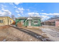 Charming green home with a well-maintained front yard and a cozy, inviting entryway at 1250 S Tennyson St, Denver, CO 80219