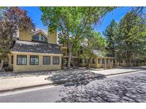 Inviting multi-level condo with classic design and mature trees offering shade and curb appeal at 980 S Dahlia St # F, Denver, CO 80246