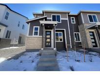 Two-story home with modern facade and snowy front yard at 22821 E Stanford Ln # B, Aurora, CO 80015