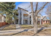 Modern two-story home with a manicured lawn and stylish architectural details at 1437 Garfield St, Denver, CO 80206