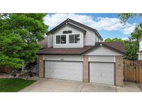 Charming two-story home featuring a three car garage and a well-maintained lawn at 13307 Humboldt Dr, Thornton, CO 80241