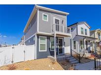 Charming two-story home featuring a modern design and inviting front porch at 5043 N Walden Way, Denver, CO 80249
