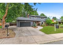 Charming two-story home featuring a two-car garage, brick accents, and a well-manicured front yard with mature trees at 4682 Chatham St, Boulder, CO 80301