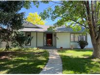 Charming single-story home with a walkway, trees and a well-maintained lawn at 53 Douglas S Dr, Broomfield, CO 80020