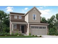 Charming two-story home with a two-car garage and a welcoming front porch at 718 N Clubview St, Watkins, CO 80137