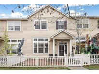 Charming two-story townhome with a well-kept front yard and a classic white picket fence at 1473 Red Cliff Way, Castle Rock, CO 80109
