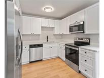 Bright kitchen featuring white cabinets, stainless steel appliances, and modern countertops at 6800 E Tennessee Ave # 541, Denver, CO 80224