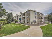 Low angle of this apartment complex with stone accents and well-maintained lawn on a cloudy day at 12338 W Dorado Pl # 107, Littleton, CO 80127