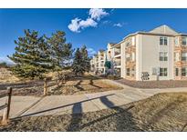 Exterior view of a multi-story residential building featuring manicured landscaping at 12338 W Dorado Pl # 107, Littleton, CO 80127